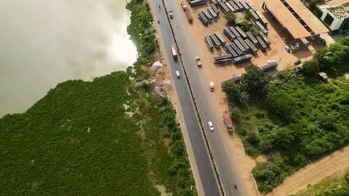 Vehicles are moving from a beautiful road in Dhaka city nearby a lake