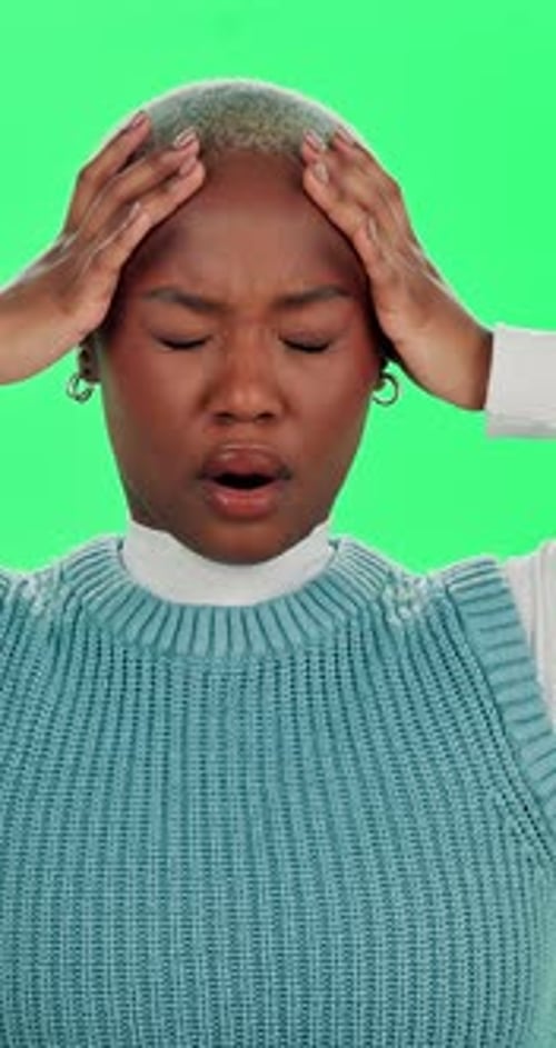 Frustrated, black woman and headache with green screen for mistake, stress