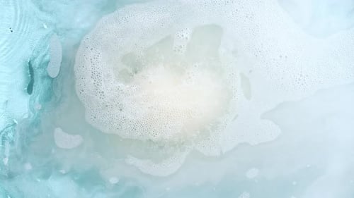 Abstract Foam Swirling in Light Blue Water