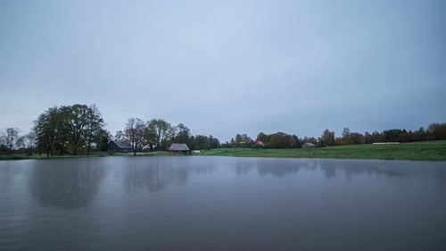 Time-lapse of changing four seasons in a year with view over dam on remote farm