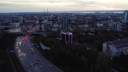 Evening City with Illuminated Skyscrapers Near Motorway