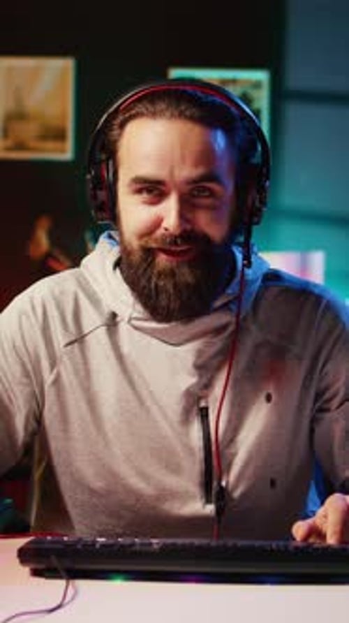 Bearded Man in Headphones Plays Video Games