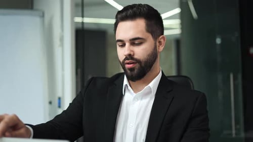 Bearded Man Doing Yoga at the Office