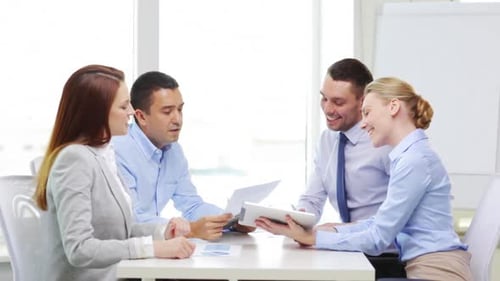 Business, Office, Teamwork and Startup Concept - Smiling Business Team with Table