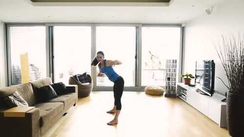 Woman Doing Yoga Warm Up Stretches Indoors