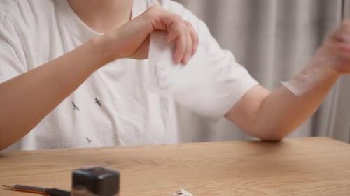 Woman hands tearing sheet of lined notebook paper into small pieces with audio