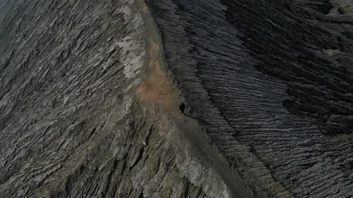 Man Walking Cliff Volcano Crater Bromo Drone View