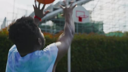 Basketball Player Shooting Outdoors on Urban Court