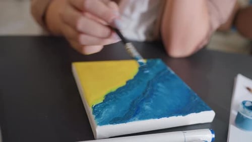 Detail Paint Process Steady Hand Applies Layered Blues Over Yellow Base Creative Studio Moment