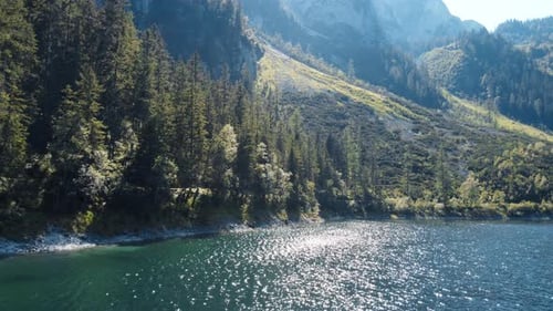 Aerial drone shot captures the pristine beauty of Lake Hallstaetter in the heart of the Alps. Crysta