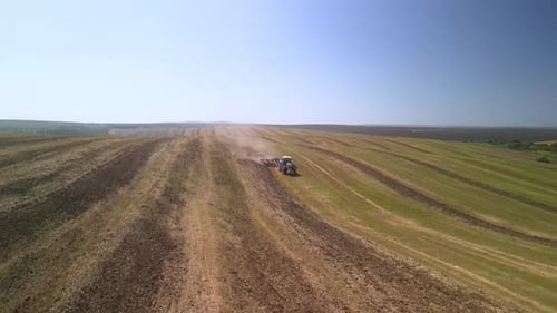 Tractor working on the field doing tillage with cultivator