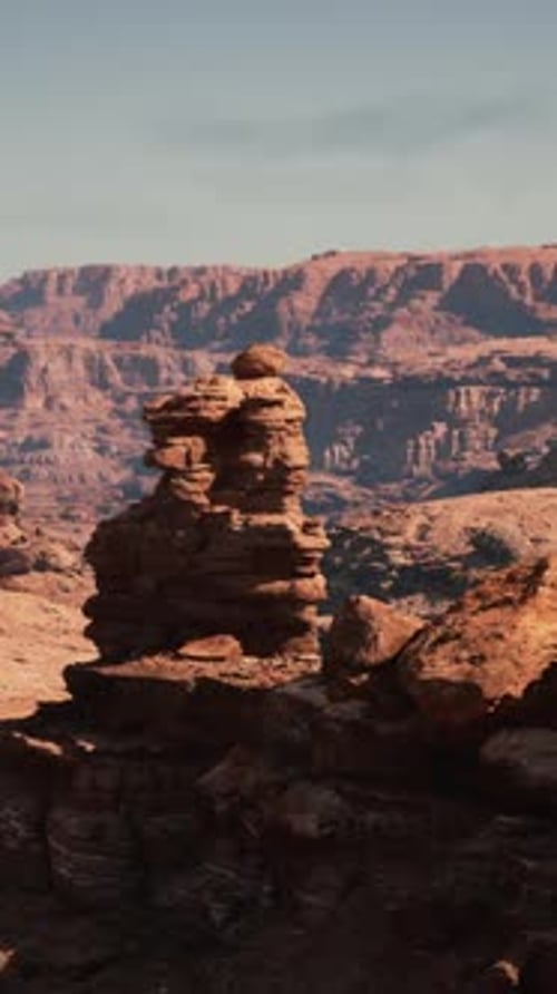 A Rocky Landscape with a Mountain in the Background
