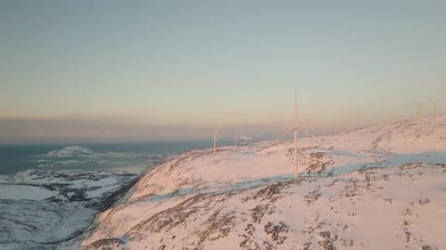 Wind power harnessed to generate clean energy, wind turbines in Arctic; drone