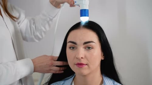Woman with Dandruff Undergoing Scalp Examination at Trichologist