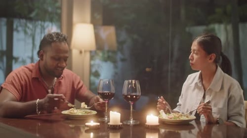 Couple Enjoying a Candlelit Dinner with Red Wine