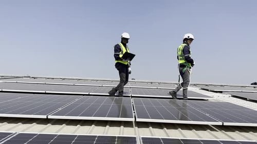 Technician installing solar cell. Installation and maintenance of solar cells on rooftop.