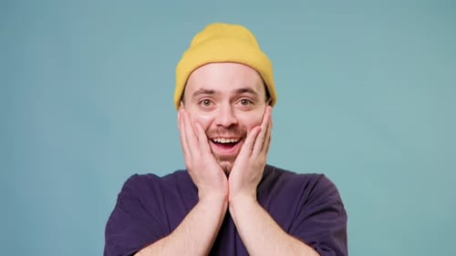 Man Expressing Shock and Surprise with Hands on Face