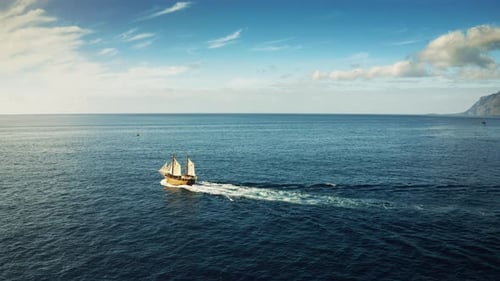 Old wooden historic ship with tourists sailing in the ocean