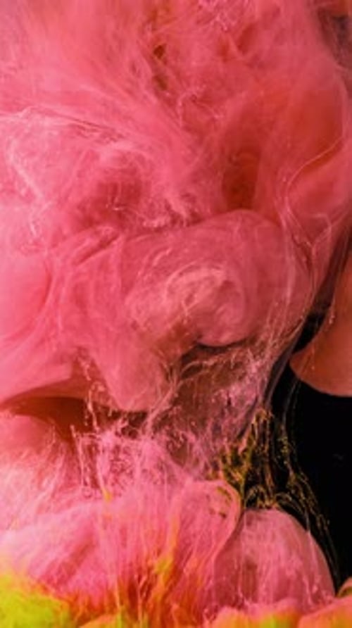 Neon inks swirling and blending in water