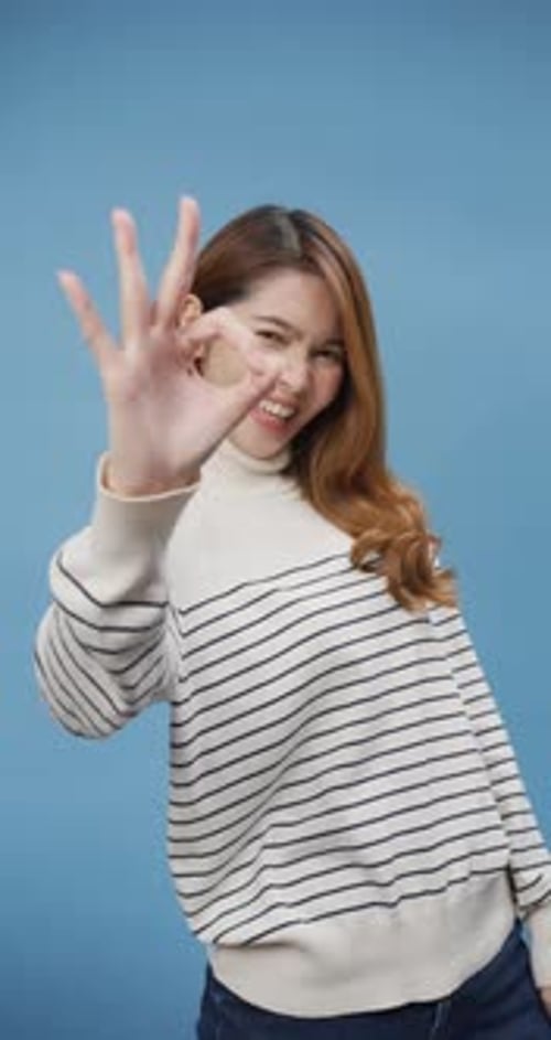 lady wear sweater cloth with okay sign good choice finger, look at camera smile stand isolate.