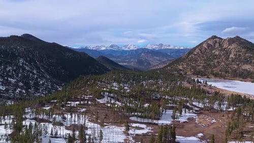 High dolly over snowy ridge and rocky valleys, Allenspark Colorado