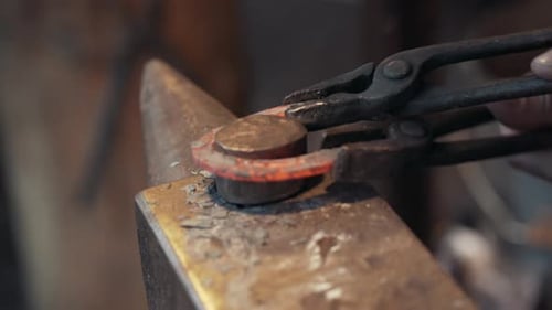 Close up of Blacksmith making a horseshoe