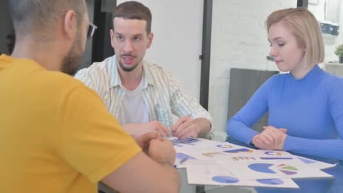 Business People Meeting to Discuss Charts at Work