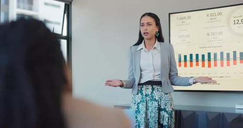Businesswoman Leading Data Presentation in Modern Office