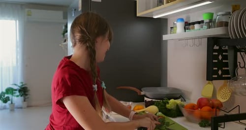 Young Woman Chopping Vegetables in Modern Kitchen