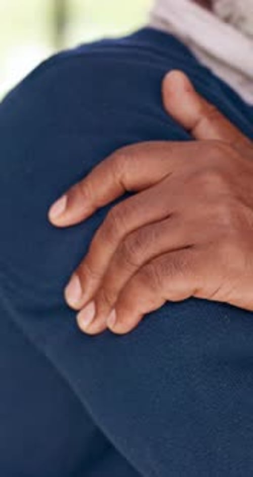 Man Holding His Injured Shoulder in Pain