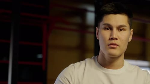 Athlete's Focused WarmUp Routine Young Athlete in Gym Focuses on Warming Up Showing Determination