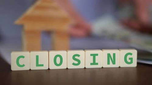 Home Closing with Money and Block Lettering