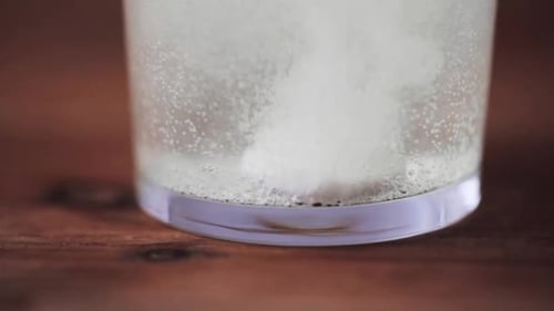 Effervescent Tablet Dissolving in Glass of Water