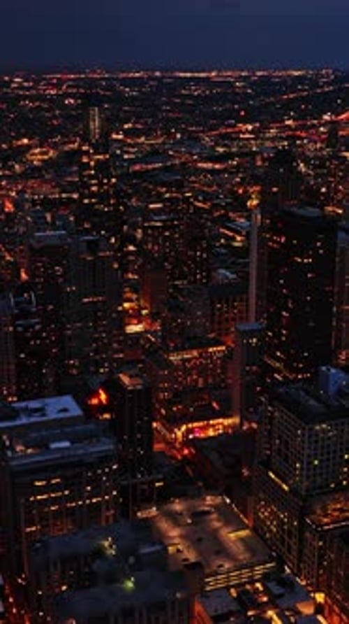 Nighttime aerial view of Chicago skyline showcasing city lights
