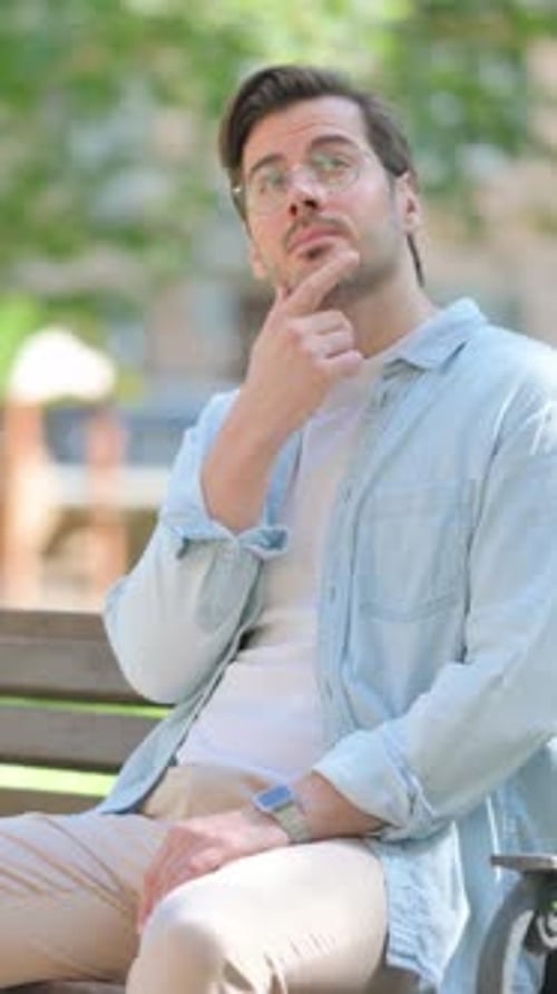 Pensive Middle Aged Man Thinking while Sitting in Park
