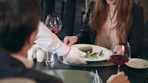 Business Woman Getting Meal on Plate at Restaurant. Waiter Serving Food For