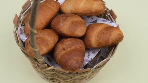 Golden Croissants in a Wicker Basket