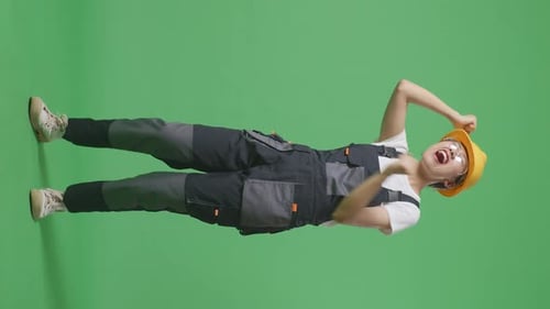 Full Body Of Asian Woman Worker Wearing Safety Helmet Singing And Dancing In The Green Screen