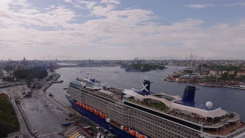 Forwards Fly Over Majestic Cruise Ship Moored at Bank in City Cityscape with Wide Watercourse