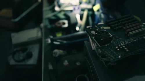 Closeup of Electronic Repair Involving Chips and Ribbon Cables