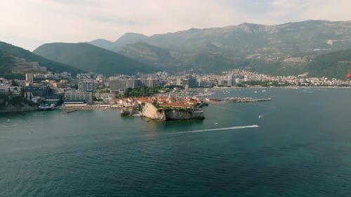 Cinematic drone view of the fortress with a church in the old town of Budva from the Adriatic Sea, w