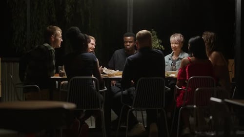 Friends Party In Backyard In Summer Evening Multiethnic Men And Women Dinning At Table On Terrace