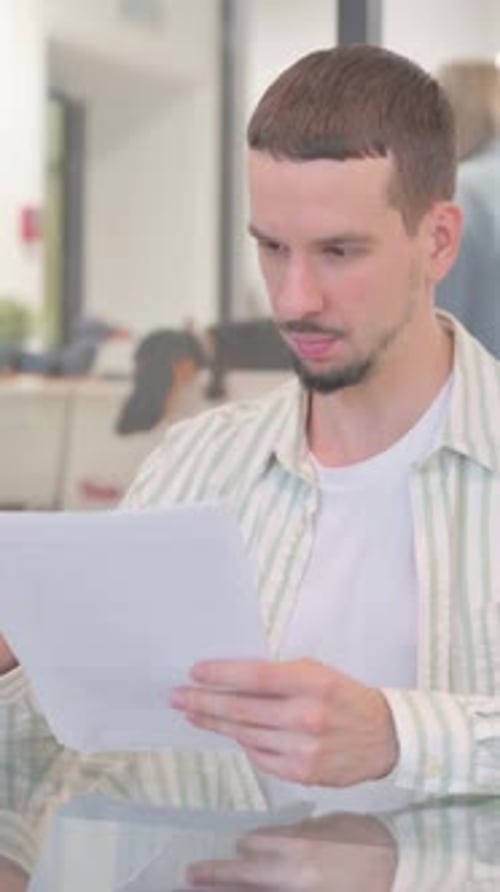 Man in Office Reading Documents