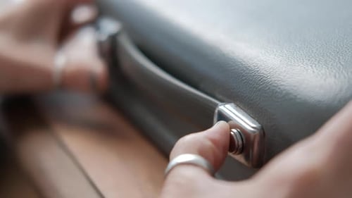 Close up caucasian woman hands opening portable typewriter