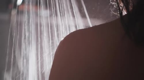 Dark-Haired Woman Showering in Close Up