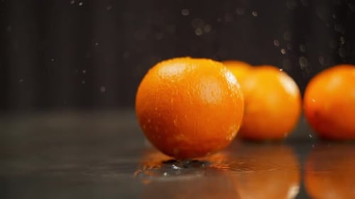 Group of Oranges are Featured in Video Where They are Being Splashed with Water