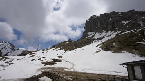 In summer, the mountain tops are covered with white clouds and snow.