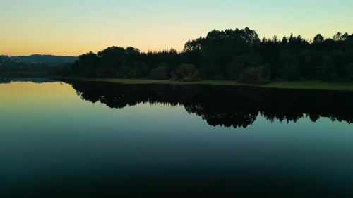 Reservoir With Mirror Reflections During Sunset In Observatorio de aves de Crendes, Spain. Wide Shot