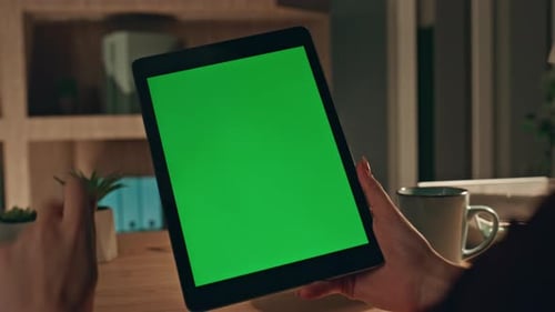 Hands Hold Tablet with Green Screen in Office