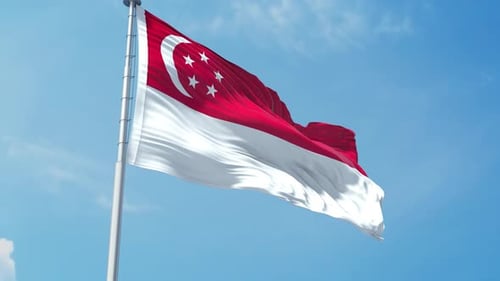 Singapore National Flag Waving Against Blue Sky
